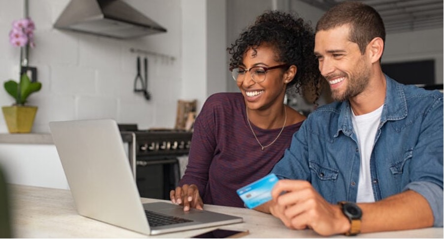 Couple looking at computer with a credit card
