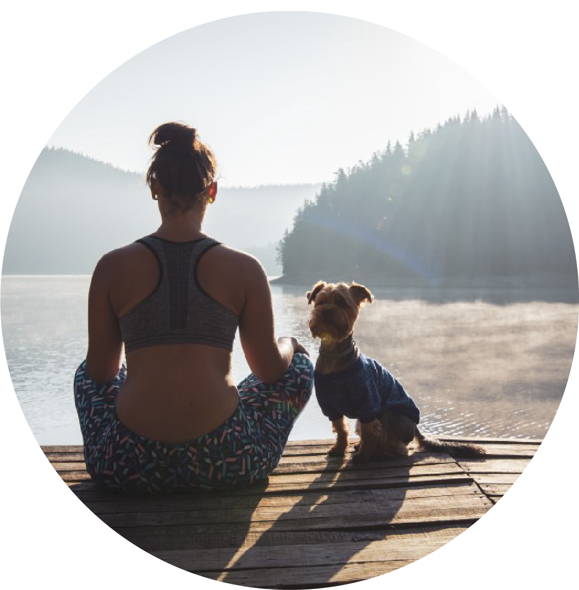 Woman relaxing on the lake with her dog