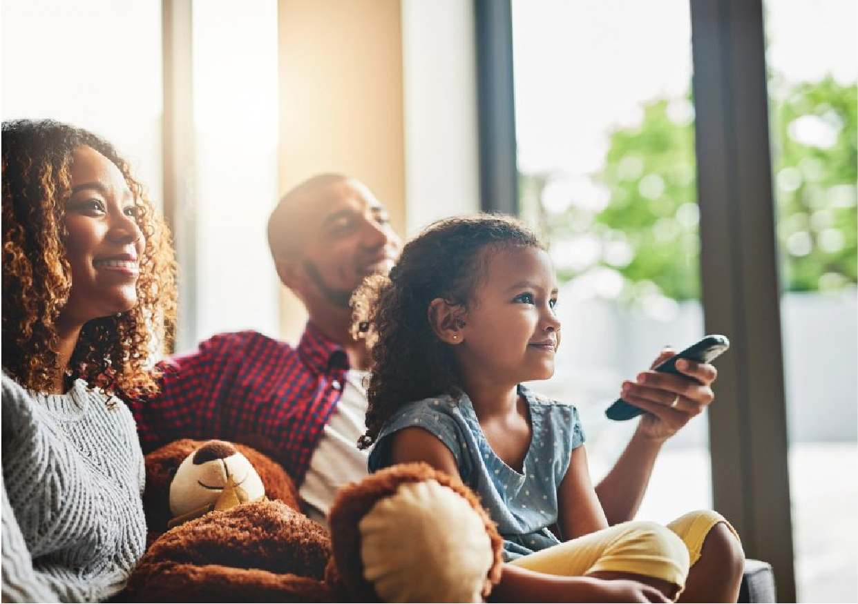 Family relaxing on the couch watching TV